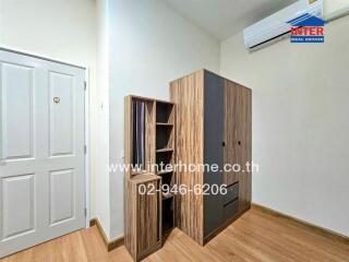 Bedroom with wooden furniture and white door