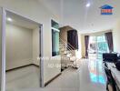 Modern living room with staircase and glass door, leading to balcony