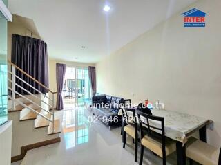 Living space with dining area and staircase