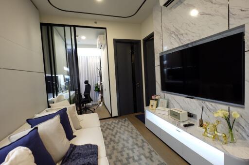 Modern living room with wall-mounted TV and comfortable seating