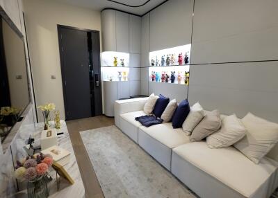 Modern living room with white sofas and display shelves