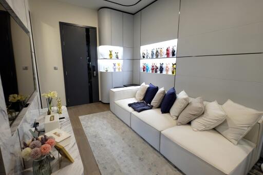 Modern living room with white sofas and display shelves