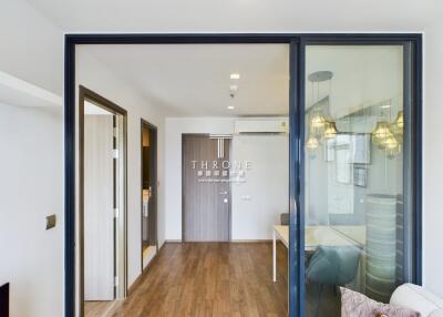 Spacious living room with glass sliding doors and wooden flooring