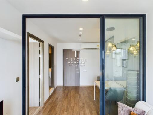 Spacious living room with glass sliding doors and wooden flooring