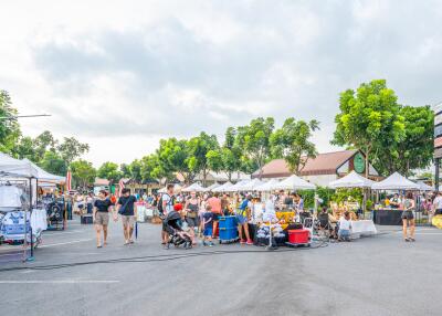 Outdoor market with people and tents