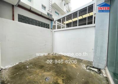 Outdoor area with concrete flooring and high walls