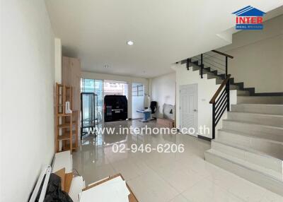 Living room with stairs and large windows