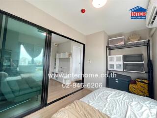 Bedroom with storage and sliding glass doors leading to another room