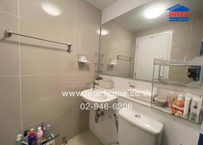 Bathroom with modern fixtures and a large mirror