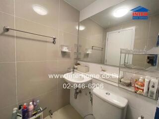 Bathroom with modern fixtures and a large mirror