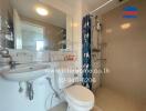 Modern bathroom with double sinks, shower area, and toilet