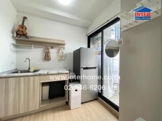 Modern kitchen with wooden cabinetry and stainless steel refrigerator
