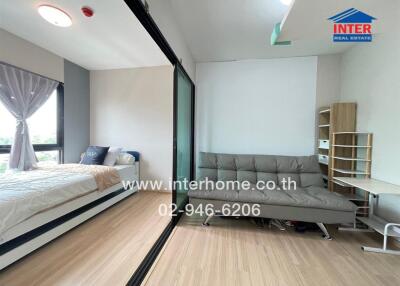 Bedroom with bed, glass partition, sofa, and shelving unit