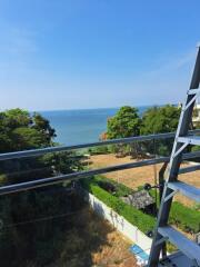 Scenic view of the sea from a balcony with glass railing and a steel structure