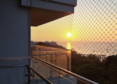 Balcony with glass railing and sunset view