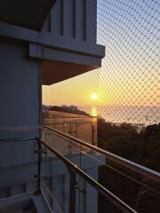 Balcony with glass railing and sunset view