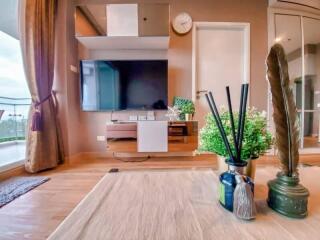 Modern living room with wall-mounted TV and balcony view