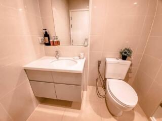 Modern bathroom with sink, mirror, and toilet