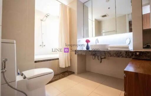 Modern bathroom with bathtub and large mirror