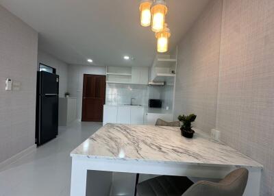 Modern kitchen with dining area and appliances