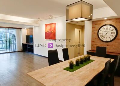 Spacious, modern living and dining area with large windows and a view.
