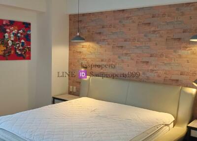 modern bedroom with brick accent wall and contemporary decor