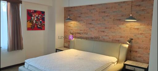 modern bedroom with brick accent wall and contemporary decor