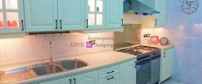 Modern kitchen with white cabinets and stainless steel appliances