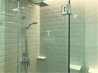 Modern bathroom with glass shower door and tiled walls
