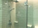 Modern bathroom with glass shower door and tiled walls