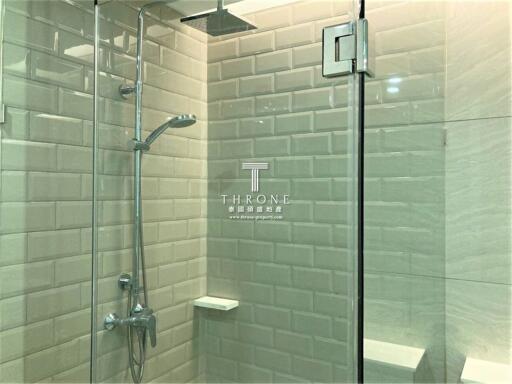 Modern bathroom with glass shower door and tiled walls