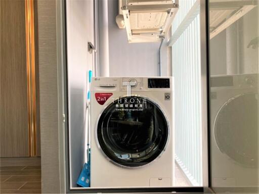 Laundry area with modern washer-dryer and storage