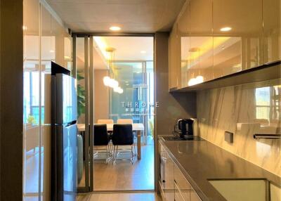 Modern kitchen with appliances and dining area in the background