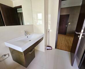 Modern bathroom with large sink and open door