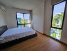A minimalist bedroom with large windows.