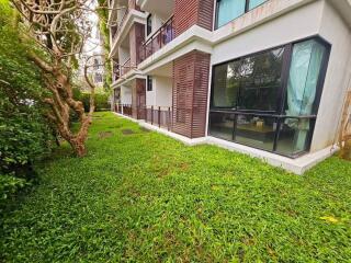 Ground floor of an apartment building with a garden