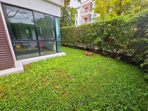 Outdoor green space with view of house