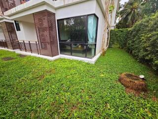 Exterior view of a building with a green backyard