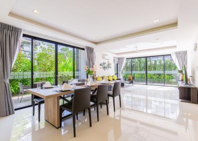 Spacious modern living and dining area with large windows and garden view