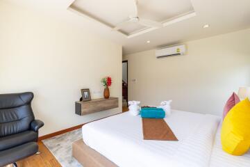 Modern bedroom with ceiling fan and air conditioning