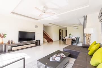 Spacious and well-lit living room with modern furniture