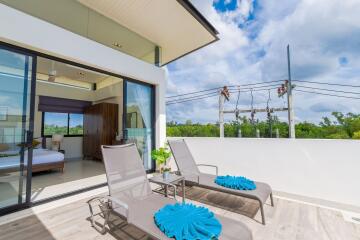 Spacious balcony with lounge chairs and view