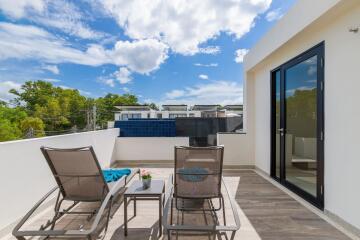 Sunny terrace with lounge chairs and table