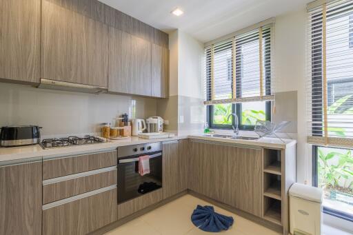 Modern kitchen with wooden cabinets and stainless steel appliances