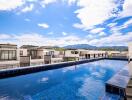 Rooftop pool with view of modern townhouses and mountains