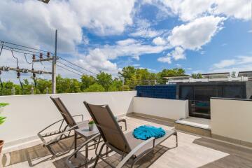 Rooftop terrace with sun loungers and blue sky