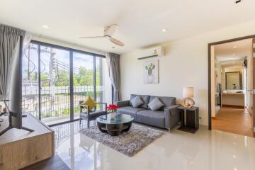 Bright living room with modern furnishings and large windows