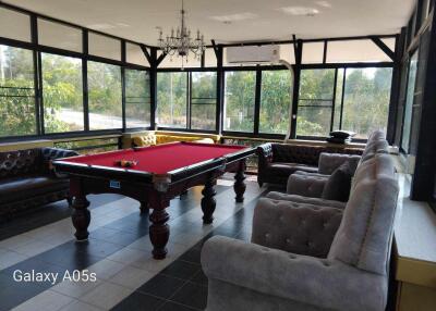 Spacious recreational room with a pool table and seating area