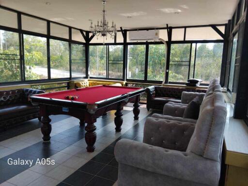 Spacious recreational room with a pool table and seating area