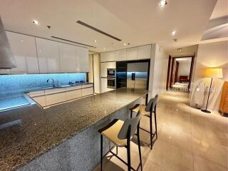 Modern kitchen with granite countertops and bar seating